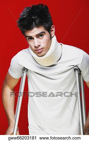 Portrait of a young man wearing a neck brace and holding crutches View Large Photo Image Stock Image - Portrait of a young man wearing a neck brace and holding crutches. Fotosearch