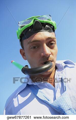 Stock Image - Portrait of a young man wearing a snorkel. Fotosearch