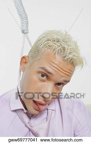 Stock Image - Portrait of a young man with a noose around his neck. Fotosearch