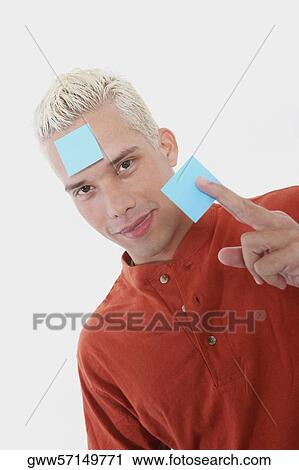 Portrait of a young man with an adhesive note on his forehead View Large Photo Image Stock Image - Portrait of a young man with an adhesive note on his forehead. Fotosearch