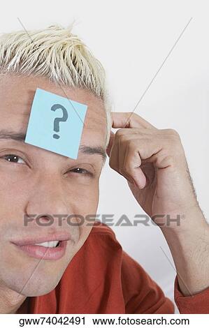 Portrait of a young man with an adhesive note on his forehead View Large Photo Image Stock Image - Portrait of a young man with an adhesive note on his forehead. Fotosearch