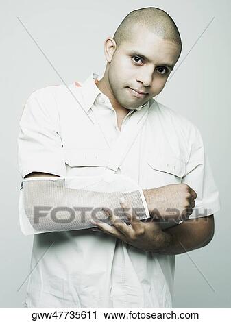 Portrait of a young man with his arm in a sling View Large Photo Image Stock Image - Portrait of a young man with his arm in a sling. Fotosearch