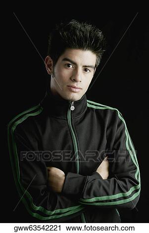 Portrait of a young man with his arms crossed View Large Photo Image Stock Image - Portrait of a young man with his arms crossed. Fotosearch