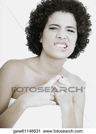 Portrait of a young woman biting her lip View Large Photo Image Stock Image - Portrait of a young woman biting her lip. Fotosearch