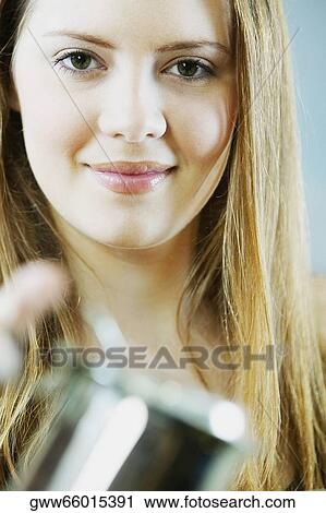 Portrait of a young woman holding a cup of tea View Large Photo Image Stock Image - Portrait of a young woman holding a cup of tea. Fotosearch