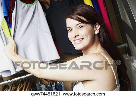 Portrait of a young woman holding a top View Large Photo Image Stock Image - Portrait of a young woman holding a top. Fotosearch