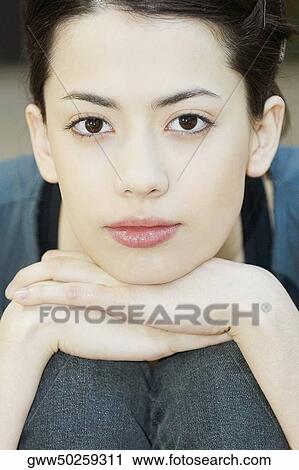 Portrait of a young woman hugging her knees View Large Photo Image Stock Image - Portrait of a young woman hugging her knees. Fotosearch