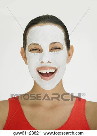 Portrait of a young woman laughing with a facial mask on her face View Large Photo Image Stock Image - Portrait of a young woman laughing with a facial mask on her face. Fotosearch