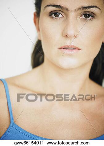 Portrait of a young woman looking serious View Large Photo Image Stock Image - Portrait of a young woman looking serious. Fotosearch