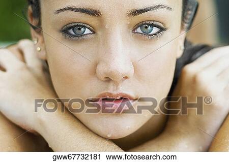 Portrait of a young woman lying at the poolside with her arms crossed View Large Photo Image Stock Image - Portrait of a young woman lying at the poolside with her arms crossed. Fotosearch