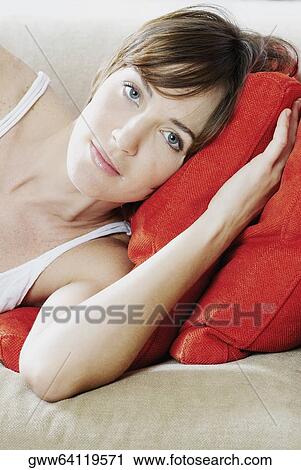 Portrait of a young woman lying on the couch View Large Photo Image Stock Image - Portrait of a young woman lying on the couch. Fotosearch