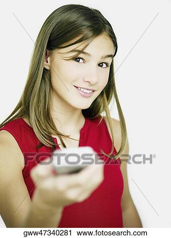 Portrait of a young woman operating a remote control View Large Photo Image Stock Image - Portrait of a young woman operating a remote control. Fotosearch