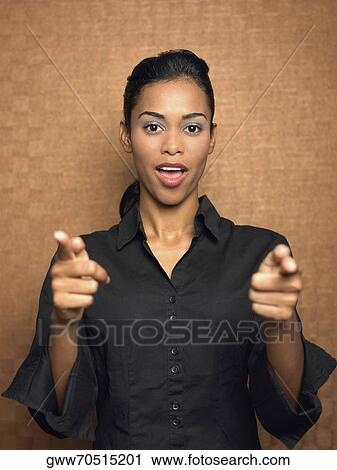 Portrait of a young woman pointing forward View Large Photo Image Stock Image - Portrait of a young woman pointing forward. Fotosearch