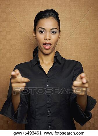 Portrait of a young woman pointing forward View Large Photo Image Stock Image - Portrait of a young woman pointing forward. Fotosearch