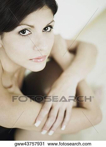 Portrait of a young woman sitting on the floor View Large Photo Image Stock Image - Portrait of a young woman sitting on the floor. Fotosearch