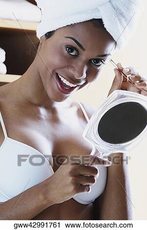 Portrait of a young woman tweezing her eyebrows and laughing View Large Photo Image Stock Image - Portrait of a young woman tweezing her eyebrows and laughing. Fotosearch