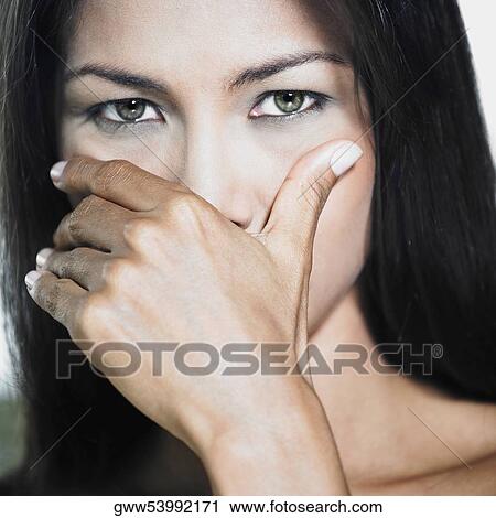 Portrait of a young woman with her hand in front of her face View Large Photo Image Stock Image - Portrait of a young woman with her hand in front of her face. Fotosearch