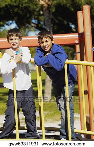 Portrait of two brothers standing together View Large Photo Image Stock Image - Portrait of two brothers standing together. Fotosearch