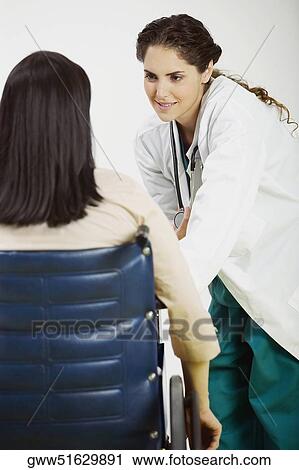 Rear view of female patient talking to a female doctor View Large Photo Image Stock Image - Rear view of female patient talking to a female doctor. Fotosearch