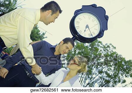 Side profile of a businessman shaking hands with a businesswoman View Large Photo Image Stock Image - Side profile of a businessman shaking hands with a businesswoman. Fotosearch