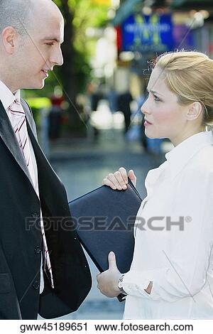Side profile of a businessman standing with a businesswoman View Large Photo Image Stock Image - Side profile of a businessman standing with a businesswoman. Fotosearch