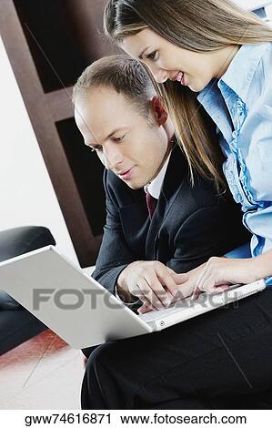 Side profile of a businessman with a teenage girl working on a laptop View Large Photo Image Stock Image - Side profile of a businessman with a teenage girl working on a laptop. Fotosearch