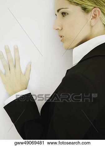 Side profile of a businesswoman leaning against a wall View Large Photo Image Stock Image - Side profile of a businesswoman leaning against a wall. Fotosearch