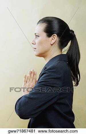 Side profile of a mature woman in a prayer position View Large Photo Image Stock Image - Side profile of a mature woman in a prayer position. Fotosearch
