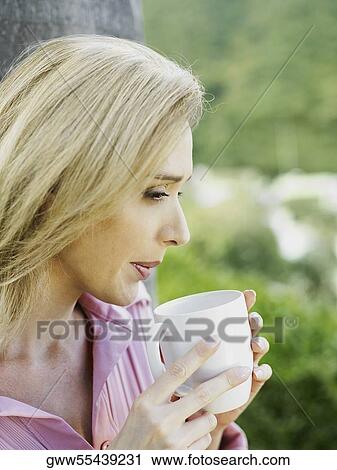 Side profile of a mid adult woman drinking tea View Large Photo Image Stock Image - Side profile of a mid adult woman drinking tea. Fotosearch