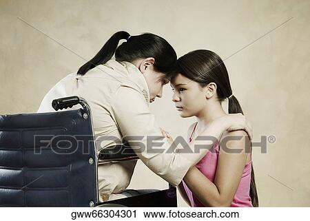 Side profile of a mid adult woman snuggling with her daughter View Large Photo Image Stock Image - Side profile of a mid adult woman snuggling with her daughter. Fotosearch