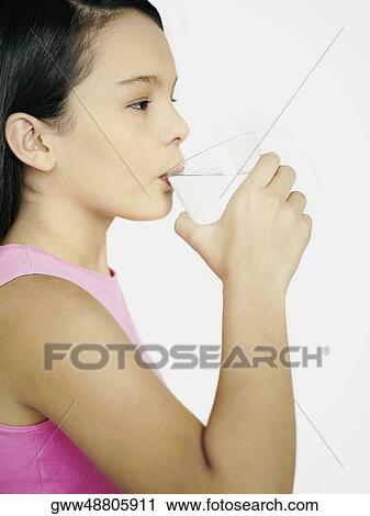 Side profile of a teenage girl drinking water from a glass View Large Photo Image Stock Image - Side profile of a teenage girl drinking water from a glass. Fotosearch