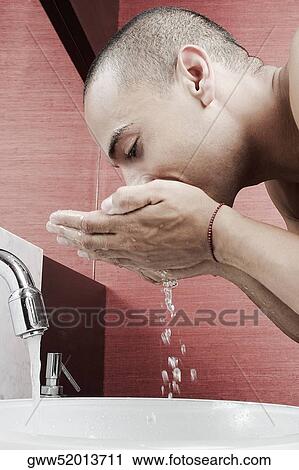 Side profile of a young man washing his face in the bathroom sink View Large Photo Image Stock Image - Side profile of a young man washing his face in the bathroom sink. Fotosearch