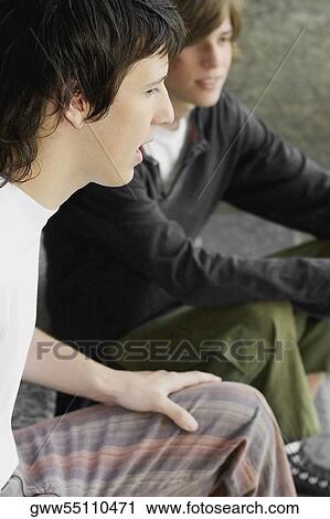 Side profile of two teenage boys sitting together View Large Photo Image Stock Image - Side profile of two teenage boys sitting together. Fotosearch