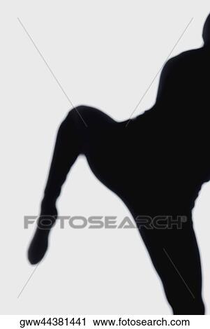 Stock Image - Silhouette of a person dancing. Fotosearch