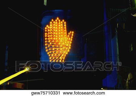 Stock Image - Stop sign lit up at night. Fotosearch