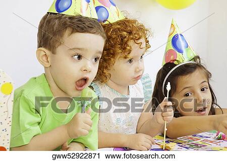 Two girls and a boy at a birthday party View Large Photo Image Stock Image - Two girls and a boy at a birthday party. Fotosearch