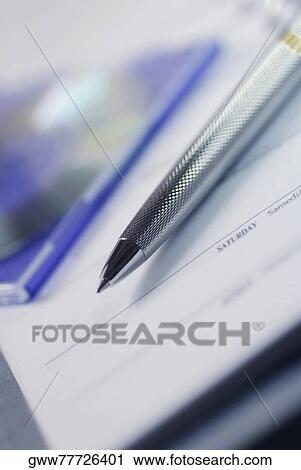 Close-up of a ballpoint pen and CD case on a sheet of paper View Large Photo Image Stock Image - Close-up of a ballpoint pen and CD case on a sheet of paper. Fotosearch
