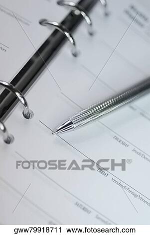 Stock Image - Close-up of a ballpoint pen on a personal organizer. Fotosearch