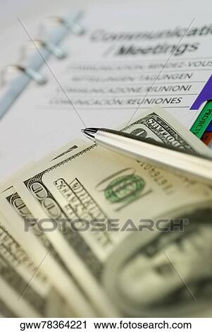 Close-up of a ballpoint pen with one hundred dollar bills on a personal organizer View Large Photo Image Stock Image - Close-up of a ballpoint pen with one hundred dollar bills on a personal organizer. Fotosearch