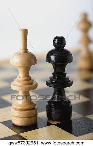 Stock Image - Close-up of a Bishop and a Queen on a chessboard. Fotosearch