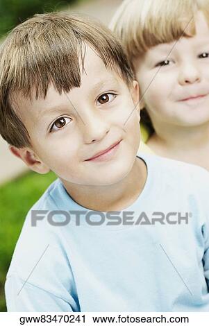 Close-up of a boy and a girl grinning View Large Photo Image Stock Image - Close-up of a boy and a girl grinning. Fotosearch