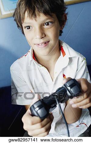Close-up of a boy playing a video game View Large Photo Image Stock Image - Close-up of a boy playing a video game. Fotosearch