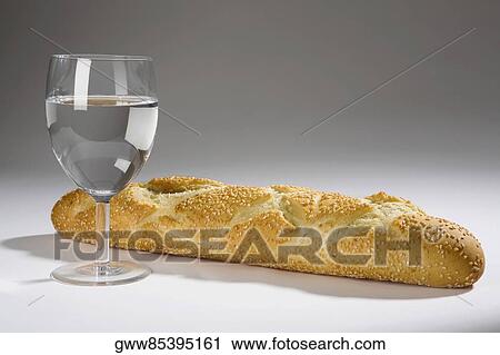 Stock Image - Close-up of a bun with a glass of wine. Fotosearch