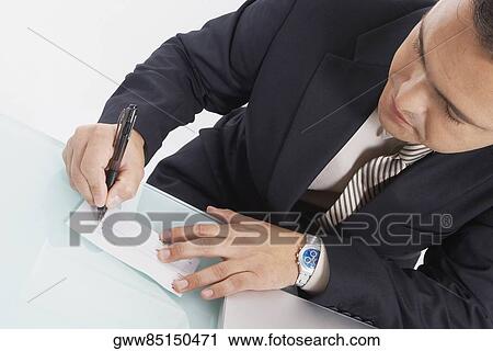 Close-up of a businessman writing a check View Large Photo Image Stock Image - Close-up of a businessman writing a check. Fotosearch