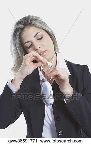 Stock Image - Close-up of a businesswoman holding a computer mouse. Fotosearch