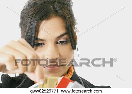 Close-up of a businesswoman picking a credit card View Large Photo Image Stock Image - Close-up of a businesswoman picking a credit card. Fotosearch