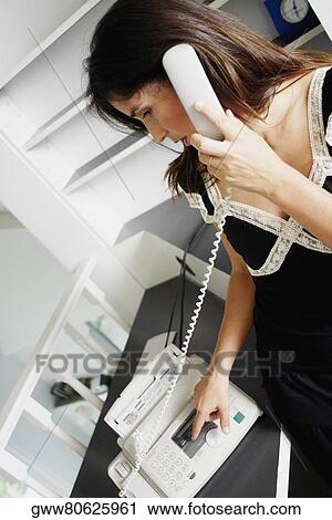 Close-up of a businesswoman using a fax machine View Large Photo Image Stock Image - Close-up of a businesswoman using a fax machine. Fotosearch