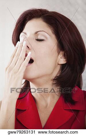 Close-up of a businesswoman yawning View Large Photo Image Stock Image - Close-up of a businesswoman yawning. Fotosearch