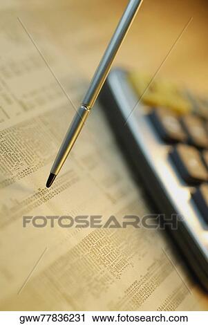 Close-up of a calculator and digitized pen on a financial newspaper View Large Photo Image Stock Image - Close-up of a calculator and digitized pen on a financial newspaper. Fotosearch