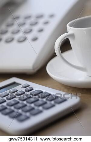 Close-up of a calculator with a tea cup View Large Photo Image Stock Image - Close-up of a calculator with a tea cup. Fotosearch